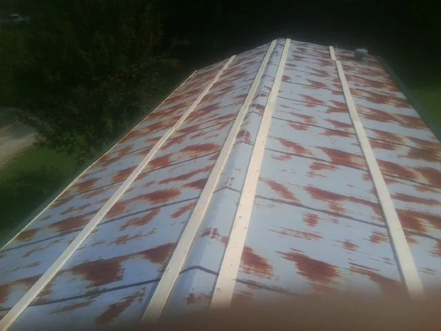 Rusted metal roof panels with new wood purlins before replacement — Storm Damage Roof Repair in Framingham by Roofing Brothers
